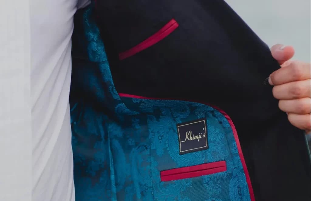 Khimji's label sewn into a teal paisley lining