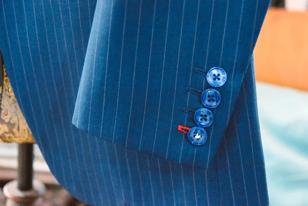 Finished sleeve buttons on a blue pinstripe jacket